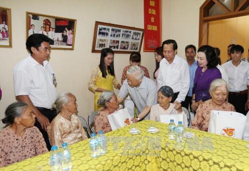 Tổng Bí thư Nguyễn Phú Trọng đến từng phòng ở, thăm hỏi, động viên và tặng quà cho người có công với cách mạng đang điều dưỡng tại Trung tâm. Ảnh: TTXVN