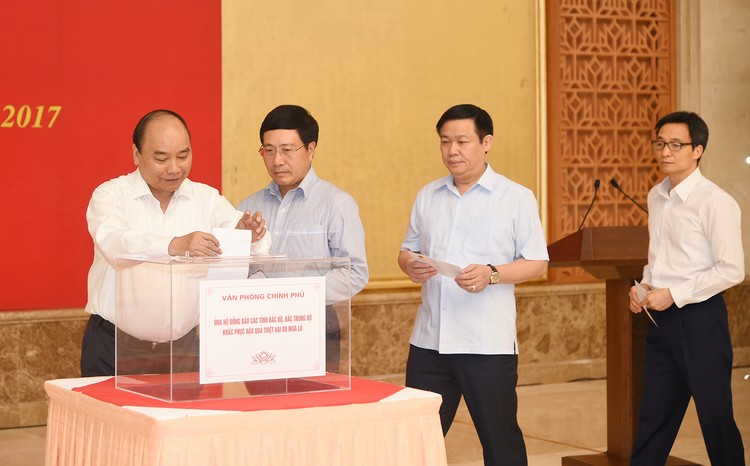 Thủ tướng Nguyễn Xuân Phúc và các Phó Thủ tướng quyên góp ủng hộ đồng bào bị ảnh hưởng lũ lụt. Ảnh: VGP