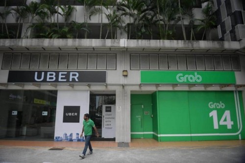 Uber đầu tuần này đã tuyên bố bán mảng Đông Nam Á cho Grab. Ảnh:Straits Times