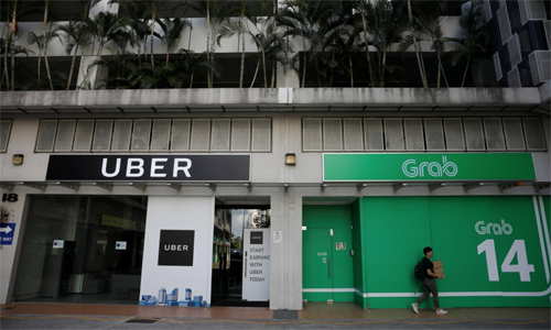 Văn phòng của Uber và Grab tại Singapore. Ảnh:Reuters.