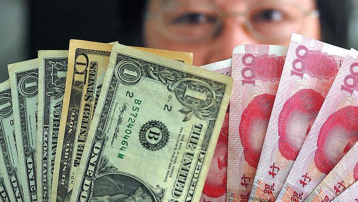 Trong vòng 1 năm trở lại đây, đồng Nhân dân tệ đã giảm giá hơn 4% o với đồng USD - Ảnh: China Daily.