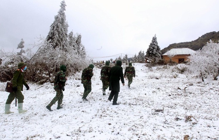 Bộ đội đồn biên phòng Y Tý (Bát Xát, Lào Cai) tuần tra trong điều kiện khắc nghiệt băng giá, mưa tuyết ngày 13/1. Ảnh: TTXVN
